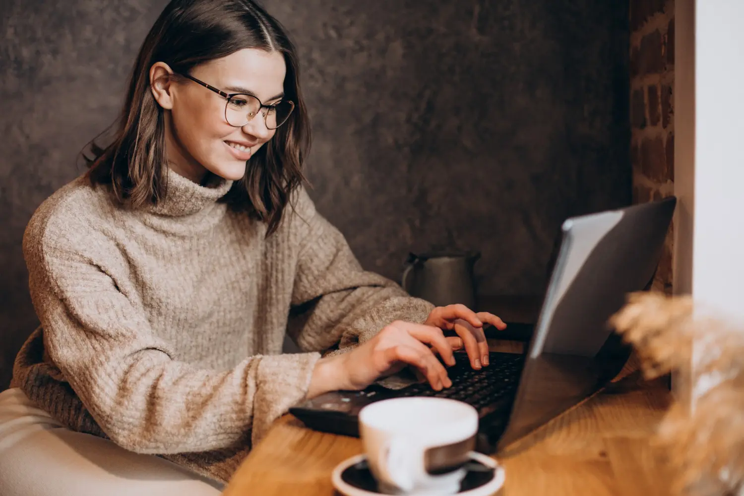 A smiling girl working on computer