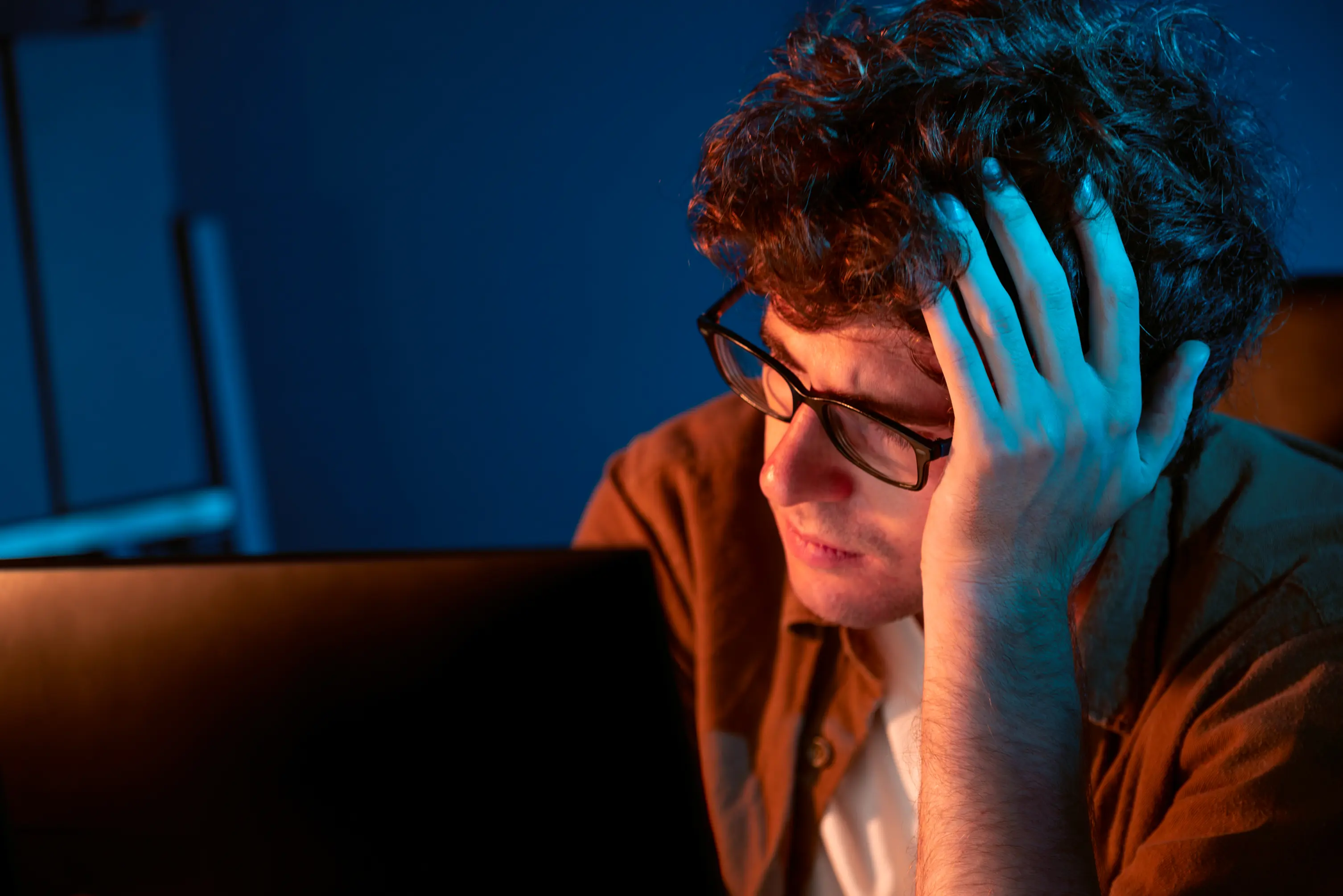 stressed project manager working on computer looking for AI solutions